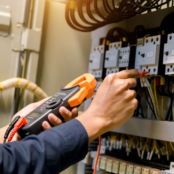 electrician working on circuit panel